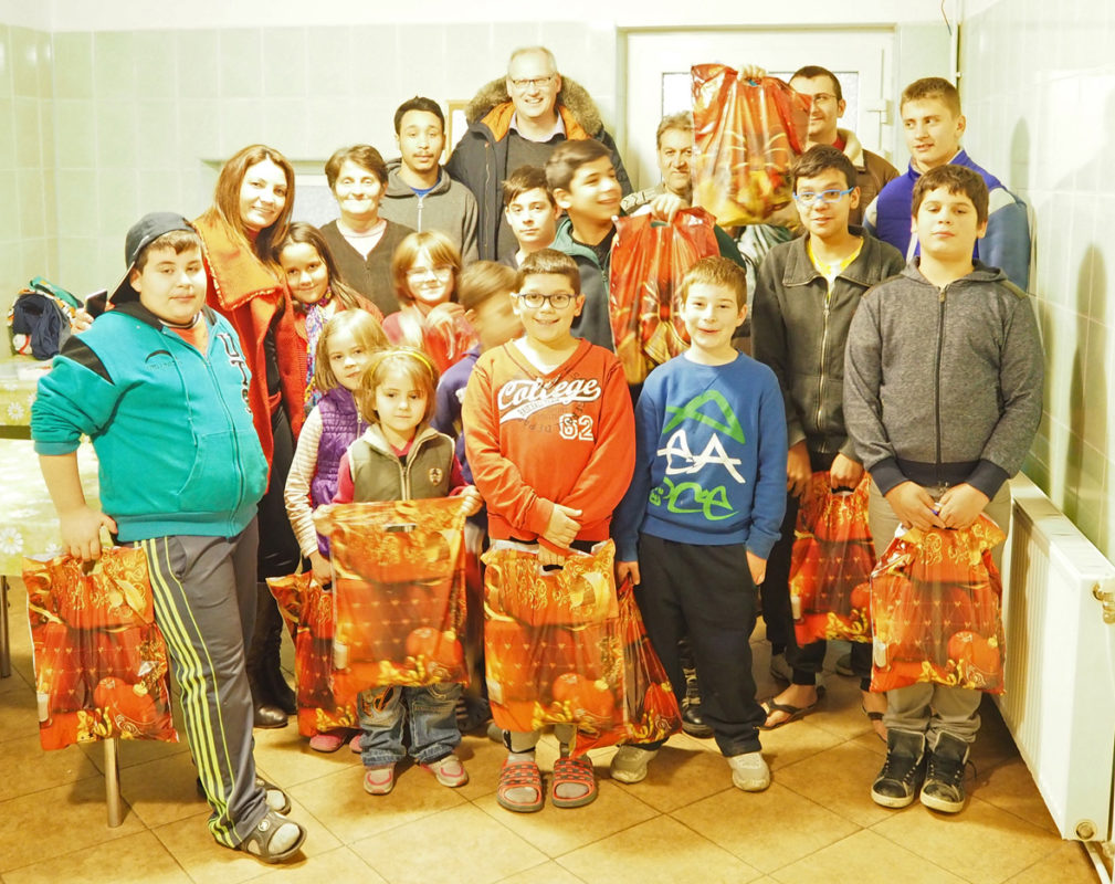 Um grupo de pessoas com sacos de presentes, simbolizando a solidariedade e o apoio.